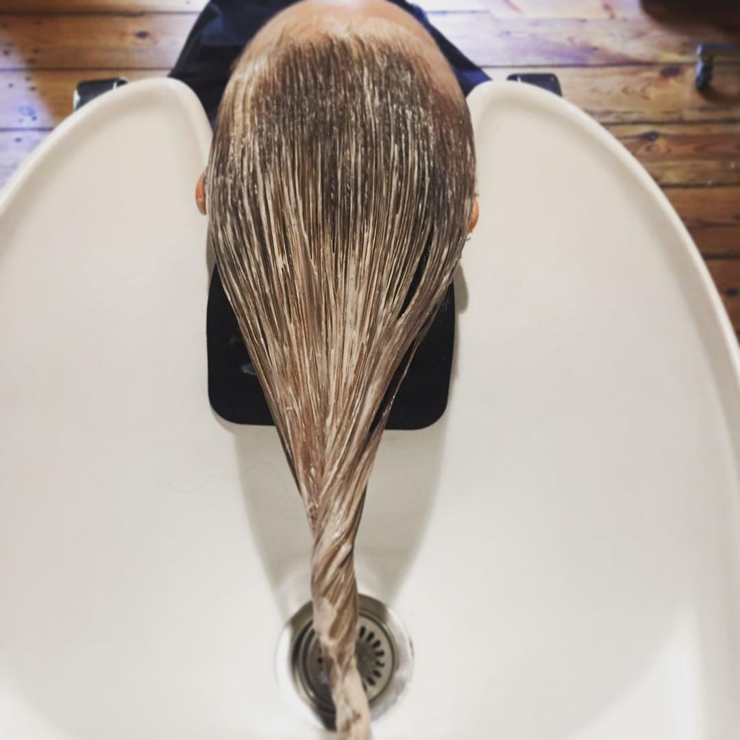Treatment in progress long blonde hair in basin at ESHK hair salon in Shoreditch