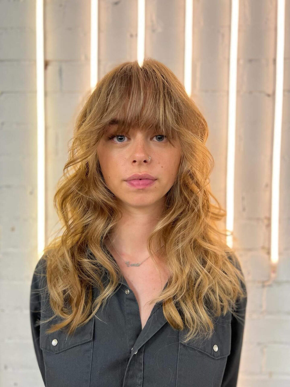 warm blonde long shaggy haircut withb 90s big blowout