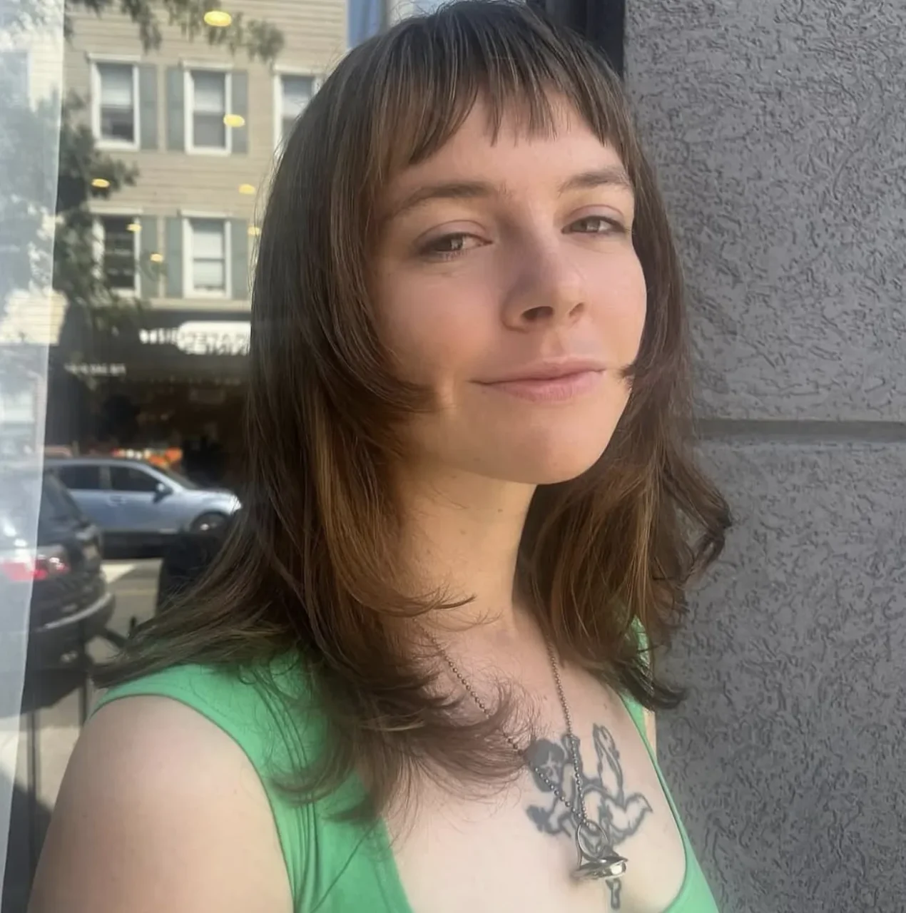 Autumnal layered hairstyle straight bangs on brown hair by Reina at ESHK Brooklyn